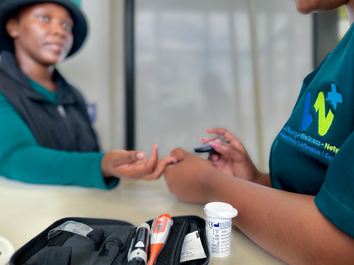 CWW conducting glucose screening on a community member